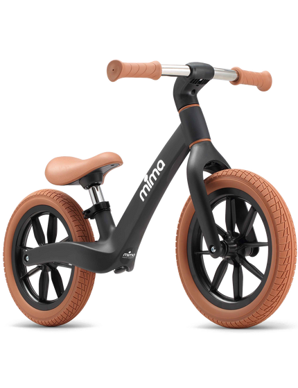 Black balance bike with a camel seat and grips
