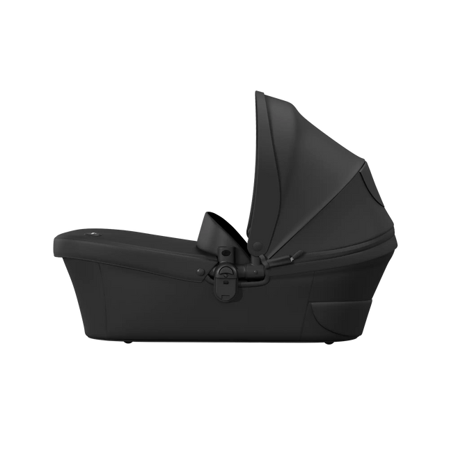 Side profile of the mima xari max bassinet with its black canopy fully extended