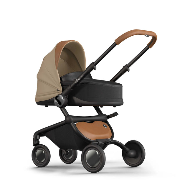mima creo bassinet in Mocha mounted on the black chassis with the canopy zipped closed