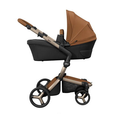 Champagne chassis mima xari max carrying the Camel bassinet, side profile with a sold separately note