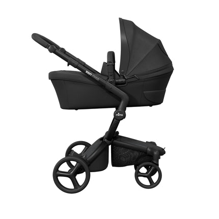 mima xari max Black stroller side on with the newborn bassinet fitted, captioned as needed for the first 6 months