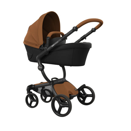Camel bassinet mounted on the mima xari max black chassis at an angle, noted as sold separately