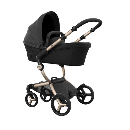 Three-quarter angle on the mima xari max Champagne chassis carrying the black bassinet, sold separately