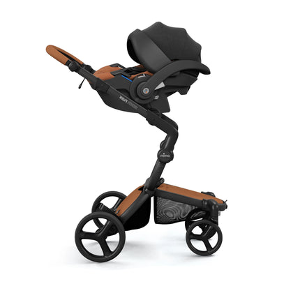 Infant car seat mounted on the mima xari max chassis using the matching car seat adapter, sold separately
