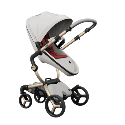 mima xari max White stroller on a Champagne chassis, parent facing with the Ruby Red seat pad