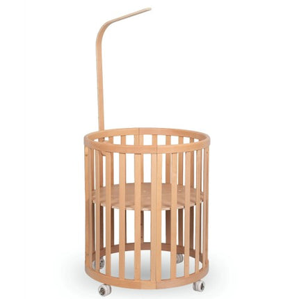 Light wood Espiro Oasis canopy frame mounted on the crib