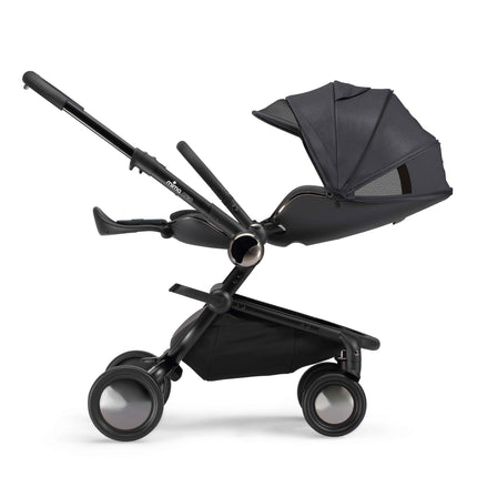 mima creo Black city stroller from the side with the parent facing seat reclined fully flat