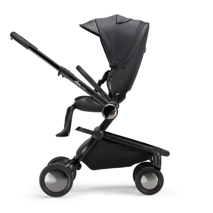 Side profile of the mima creo Black city stroller with the seat upright and facing the parent