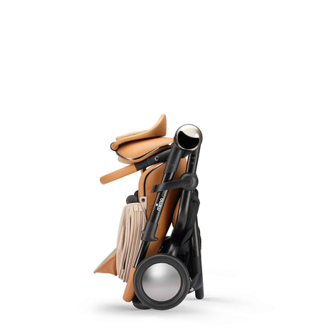 mima creo Mocha stroller folded and standing upright on its own, compact side view