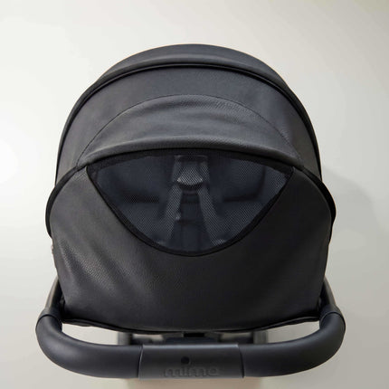 Peekaboo mesh window in the extended canopy of the mima miro Black travel stroller, seen from above