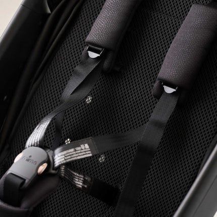 Breathable mesh seat pad and 5-point harness buckle on the mima miro Black travel stroller