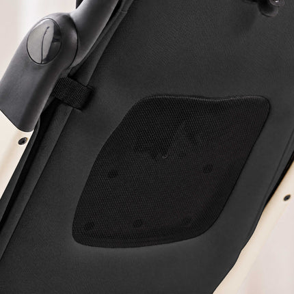 Close-up of the diamond mesh vent panel on the dark backrest of the mima miro White travel stroller