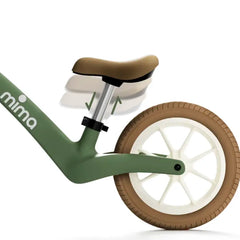 Close-up of the adjustable seat height on a green mima zoom lite balance bike